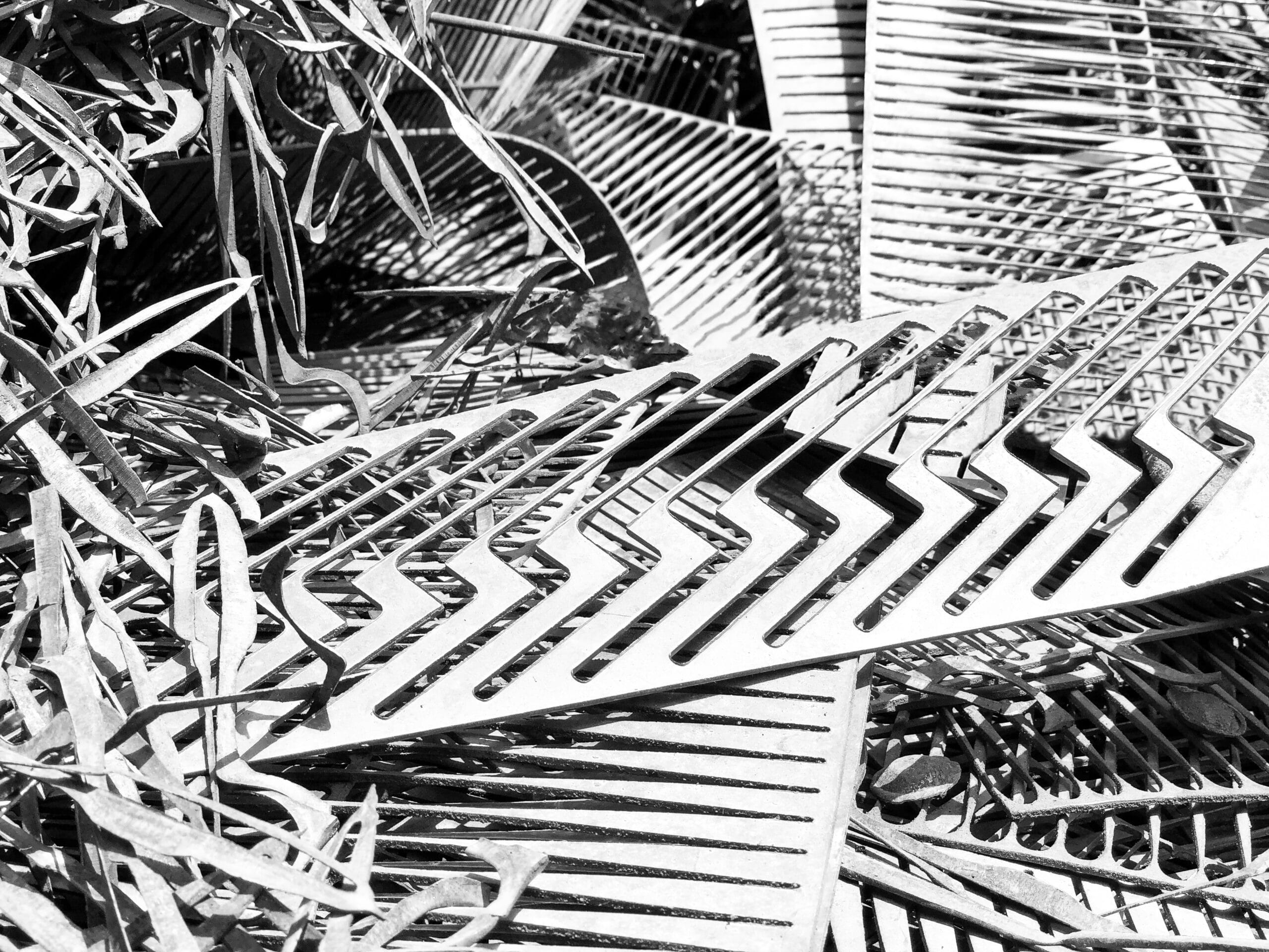 a black and white photo of a pile of metal pieces
