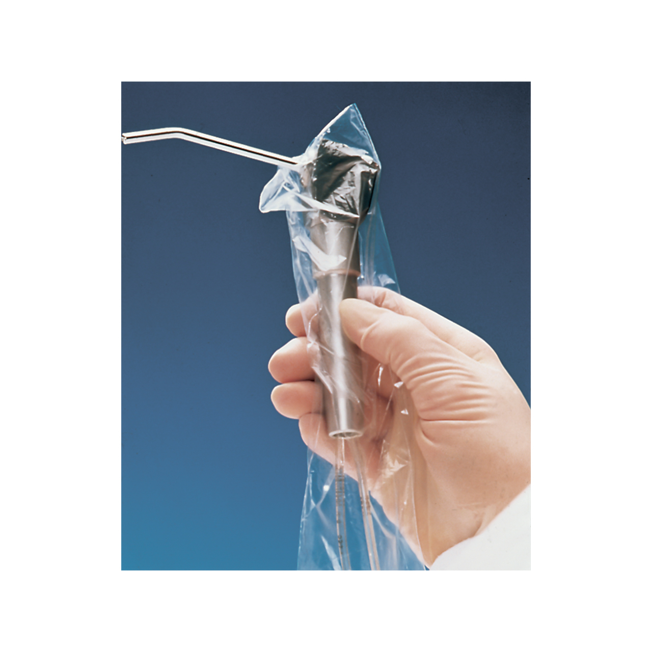 a person is holding a stainless steel air and water syringe in a clear plastic bag.