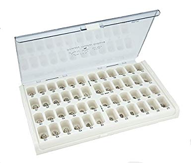 a white box filled with a variety of dental instruments